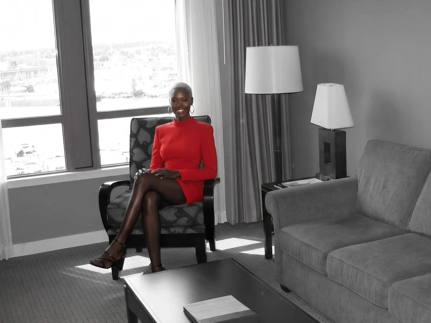 A woman in an armchair of a River Rock suite